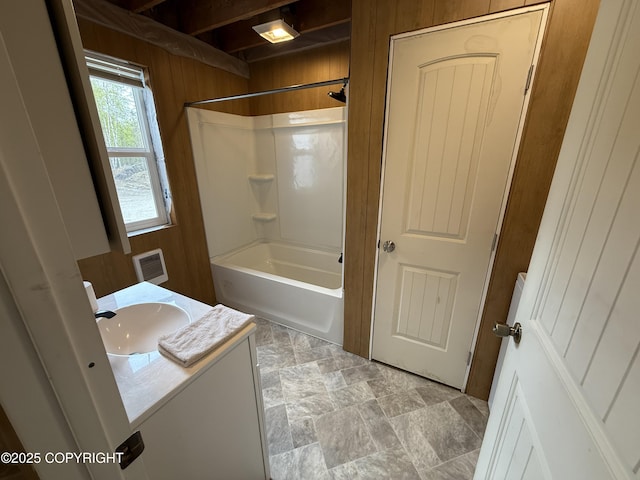26155 W Long Lake Rd, Willow, AK 99688 - bathroom with wooden walls, washtub / shower combination, and vanity