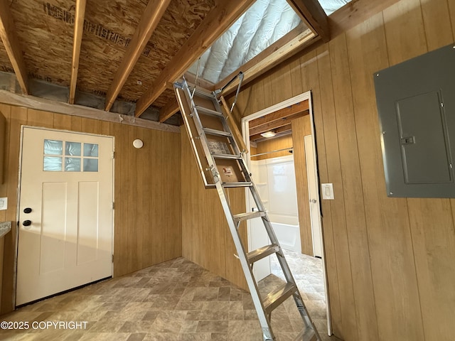26155 W Long Lake Rd, Willow, AK 99688 - foyer with electric panel, wooden walls, stairway, and stone finish floors