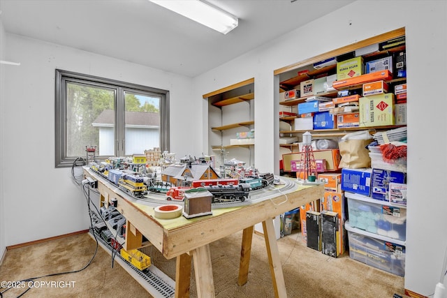 dining space featuring a workshop area and carpet flooring