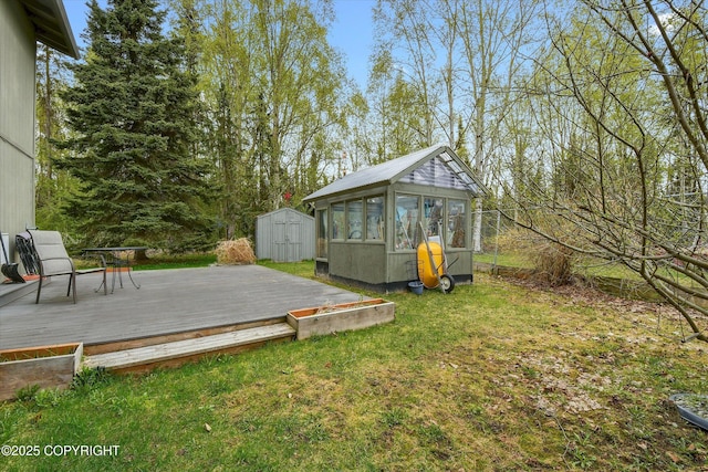view of yard with a storage shed, an outdoor structure, and a deck
