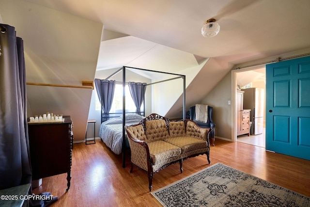 3625 W Hill Rd, Homer, AK 99603 - bedroom with wood finished floors, vaulted ceiling, and baseboards