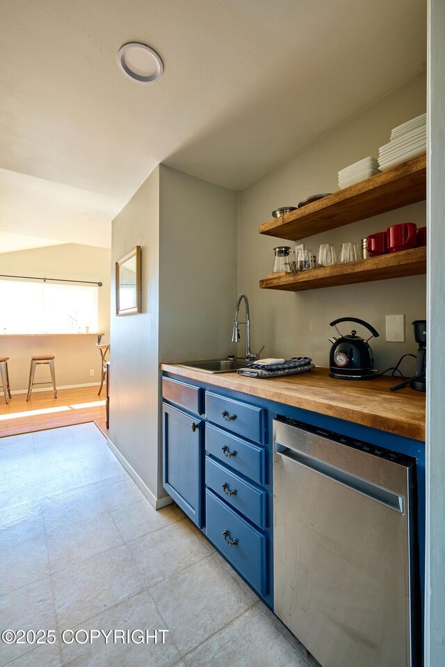 3625 W Hill Rd, Homer, AK 99603 - bar featuring a sink, dishwasher, baseboards, and light tile patterned floors