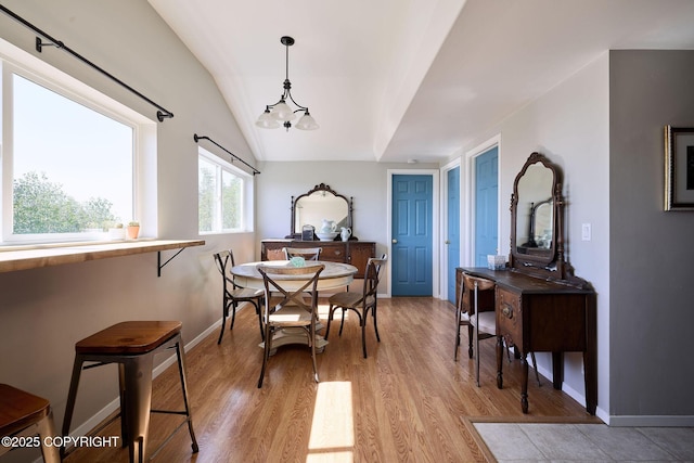 3625 W Hill Rd, Homer, AK 99603 - dining space featuring light wood finished floors, vaulted ceiling, a chandelier, and baseboards