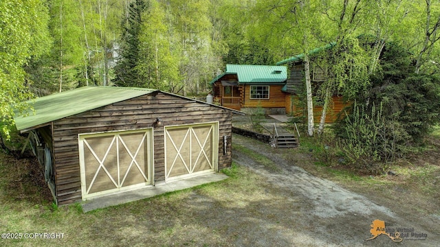20811 Eagle River Rd, Eagle River, AK 99577 - view of outdoor structure with an outdoor structure, a view of trees, and dirt driveway