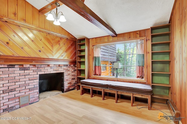 20811 Eagle River Rd, Eagle River, AK 99577 - unfurnished room featuring wooden walls, wood finished floors, a baseboard radiator, a chandelier, and a fireplace