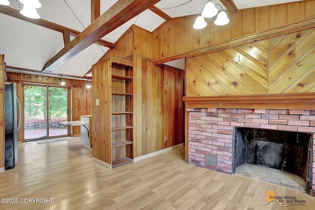 20811 Eagle River Rd, Eagle River, AK 99577 - unfurnished living room featuring wood walls, wood finished floors, a chandelier, a fireplace, and baseboards