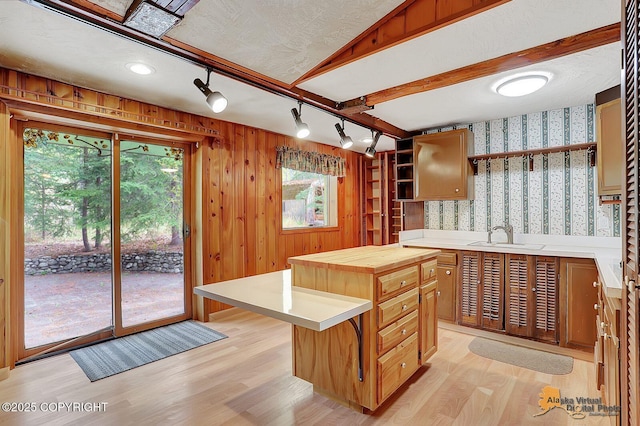 20811 Eagle River Rd, Eagle River, AK 99577 - kitchen with wallpapered walls, a sink, light wood-style flooring, wood counters, and open shelves