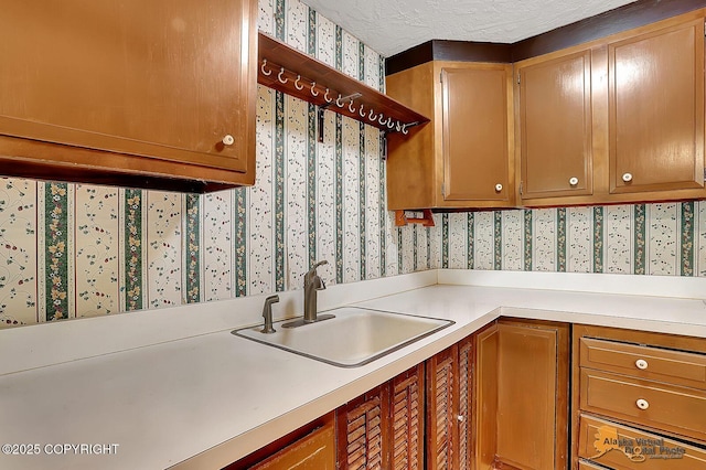 20811 Eagle River Rd, Eagle River, AK 99577 - kitchen with wallpapered walls, a sink, and light countertops