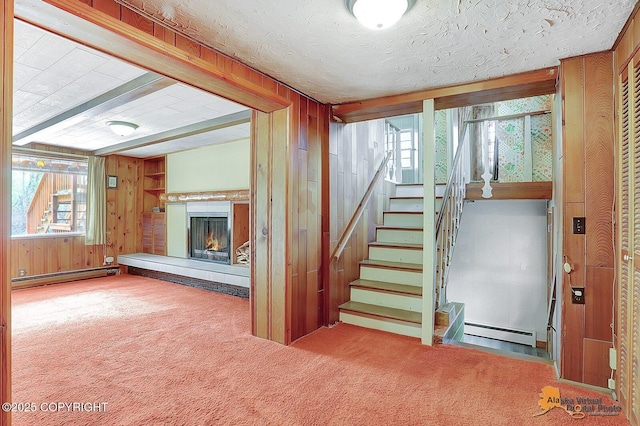 20811 Eagle River Rd, Eagle River, AK 99577 - stairs with baseboard heating, a baseboard heating unit, carpet flooring, wooden walls, and a warm lit fireplace