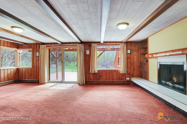 20811 Eagle River Rd, Eagle River, AK 99577 - unfurnished living room featuring wooden walls, a warm lit fireplace, carpet, beam ceiling, and baseboard heating