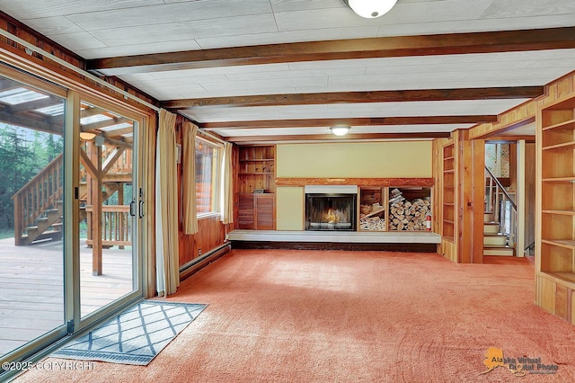 20811 Eagle River Rd, Eagle River, AK 99577 - unfurnished living room with stairs, carpet, a glass covered fireplace, beamed ceiling, and wooden walls
