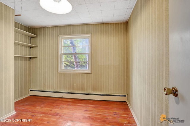 20811 Eagle River Rd, Eagle River, AK 99577 - empty room with a baseboard radiator and hardwood / wood-style flooring