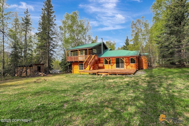 20811 Eagle River Rd, Eagle River, AK 99577 - back of property featuring a deck, a lawn, and metal roof