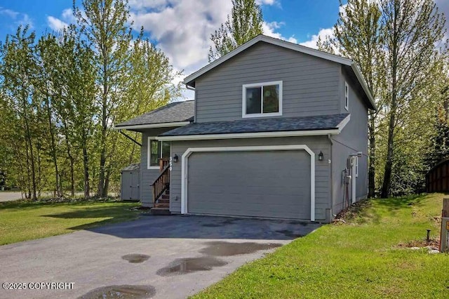view of front of home with a garage, a front yard, asphalt driveway, and a shed