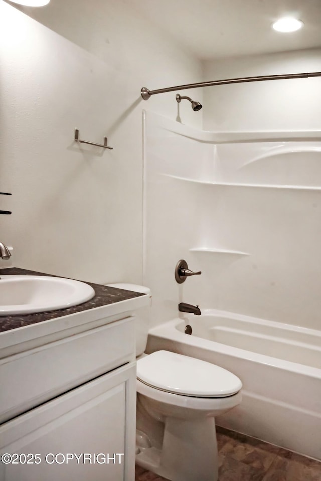 bathroom with vanity, shower / bathtub combination, and toilet