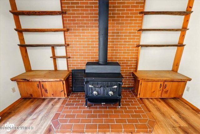 36115 Mackey Lake Rd, Soldotna, AK 99669 - detailed view of a wood stove, wood finished floors, and baseboards