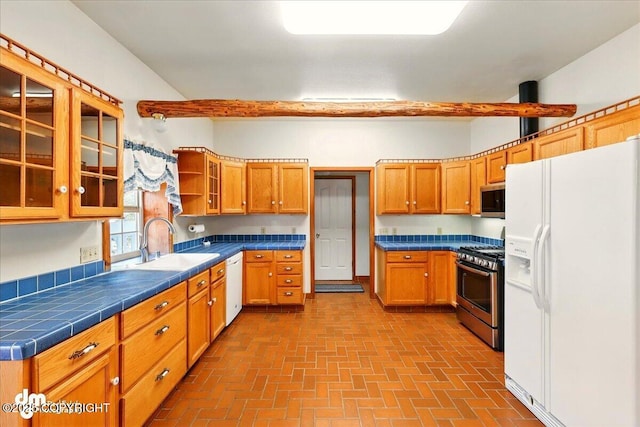 36115 Mackey Lake Rd, Soldotna, AK 99669 - kitchen featuring appliances with stainless steel finishes, a sink, brick patterned floors, and tile counters