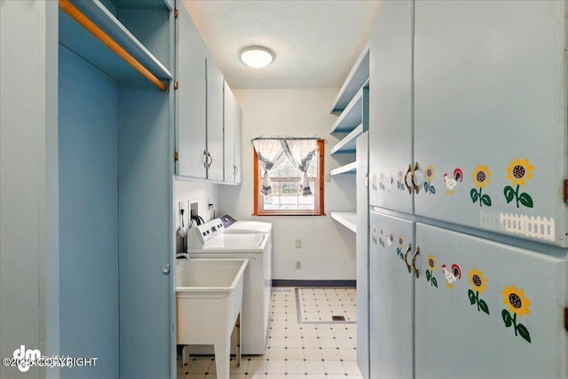 36115 Mackey Lake Rd, Soldotna, AK 99669 - clothes washing area with washing machine and clothes dryer, cabinet space, light flooring, and baseboards