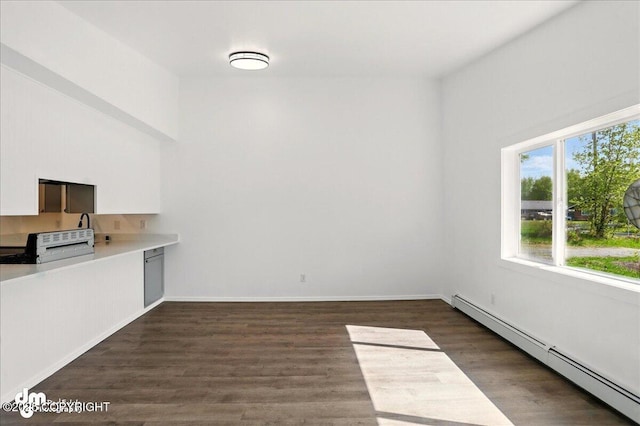 961 E Dellwood St, Wasilla, AK 99654 - unfurnished dining area featuring a baseboard heating unit, dark wood-type flooring, and baseboards