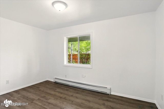 961 E Dellwood St, Wasilla, AK 99654 - empty room with a baseboard heating unit, dark wood-style floors, and baseboards