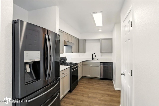 961 E Dellwood St, Wasilla, AK 99654 - kitchen featuring black appliances, under cabinet range hood, gray cabinetry, and a sink