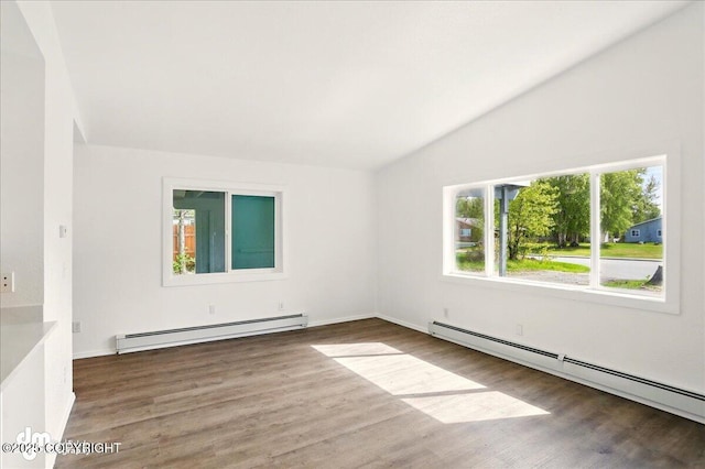 961 E Dellwood St, Wasilla, AK 99654 - empty room featuring a baseboard radiator, wood finished floors, vaulted ceiling, and baseboards