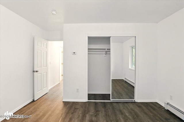 961 E Dellwood St, Wasilla, AK 99654 - unfurnished bedroom featuring baseboard heating, wood finished floors, and baseboards