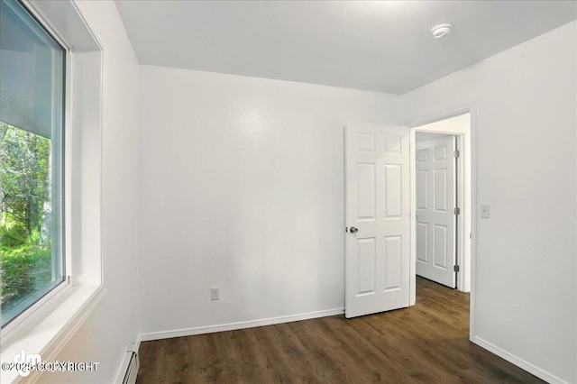 961 E Dellwood St, Wasilla, AK 99654 - empty room featuring plenty of natural light, dark wood-style flooring, and baseboards