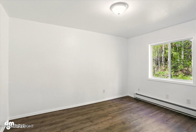 961 E Dellwood St, Wasilla, AK 99654 - spare room featuring baseboard heating, dark wood-type flooring, and baseboards