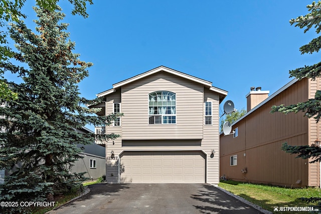 1957 Terrebonne Loop, Anchorage, AK 99502 - view of front facade with driveway and an attached garage
