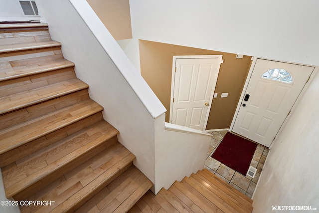 1957 Terrebonne Loop, Anchorage, AK 99502 - entryway featuring stairway and light wood finished floors