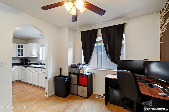 1957 Terrebonne Loop, Anchorage, AK 99502 - office area with arched walkways, light wood-style floors, and a ceiling fan