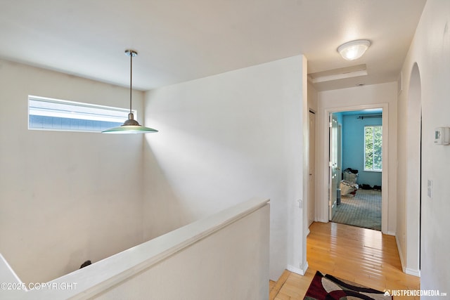 1957 Terrebonne Loop, Anchorage, AK 99502 - hall featuring light wood finished floors, arched walkways, and an upstairs landing