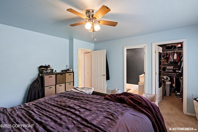 1957 Terrebonne Loop, Anchorage, AK 99502 - bedroom with a spacious closet, a closet, light colored carpet, connected bathroom, and a ceiling fan