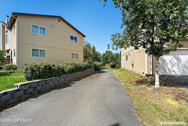 1957 Terrebonne Loop, Anchorage, AK 99502 - view of home's exterior with a garage and asphalt driveway
