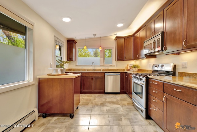 kitchen featuring appliances with stainless steel finishes, baseboard heating, decorative light fixtures, brown cabinetry, and recessed lighting
