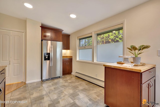 kitchen with stainless steel refrigerator with ice dispenser, a baseboard radiator, wooden counters, baseboards, and recessed lighting