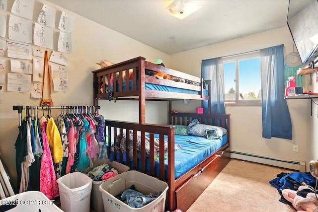 bedroom with a baseboard radiator and wood finished floors