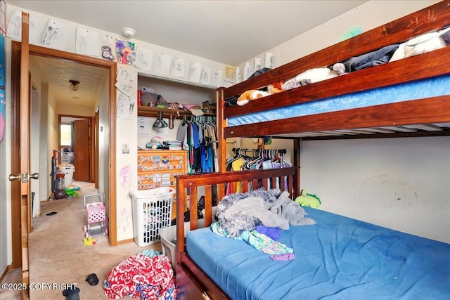 bedroom with carpet and a closet