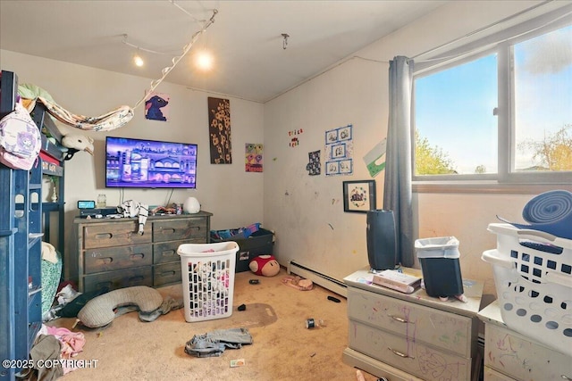 bedroom with baseboard heating and carpet