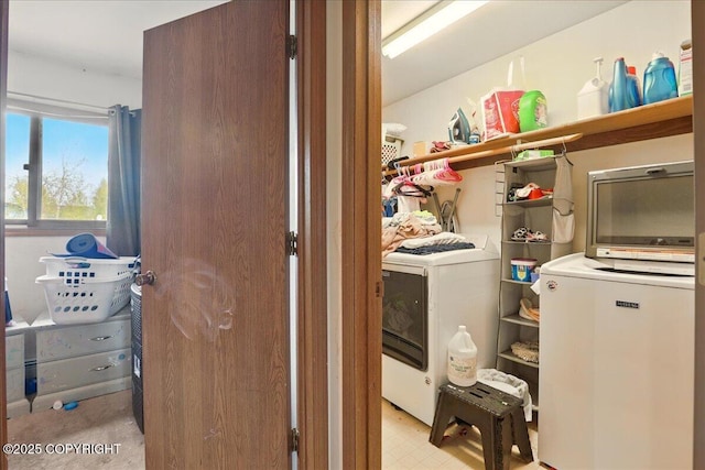 clothes washing area featuring washer / dryer