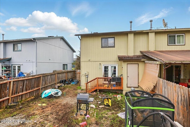 back of house featuring a fenced backyard and a wooden deck