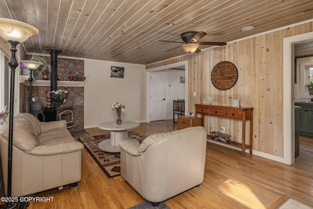 1061 E Agate Ln, Wasilla, AK 99654 - living area with wood walls, wood ceiling, ceiling fan, wood finished floors, and baseboards