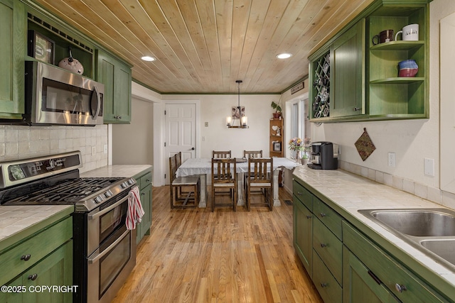 1061 E Agate Ln, Wasilla, AK 99654 - kitchen featuring green cabinetry, appliances with stainless steel finishes, tile countertops, wood ceiling, and open shelves