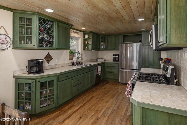 1061 E Agate Ln, Wasilla, AK 99654 - kitchen featuring green cabinetry, stainless steel appliances, a sink, tile countertops, and wood ceiling