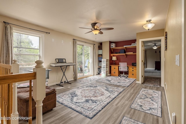 1061 E Agate Ln, Wasilla, AK 99654 - home office featuring a ceiling fan, wood finished floors, and baseboards