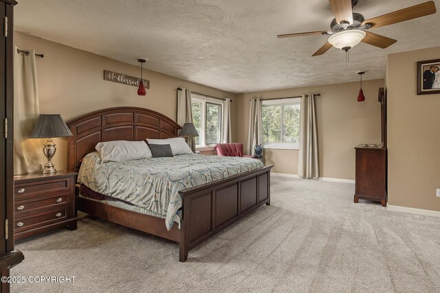 1061 E Agate Ln, Wasilla, AK 99654 - bedroom with light carpet, a textured ceiling, baseboards, and ceiling fan