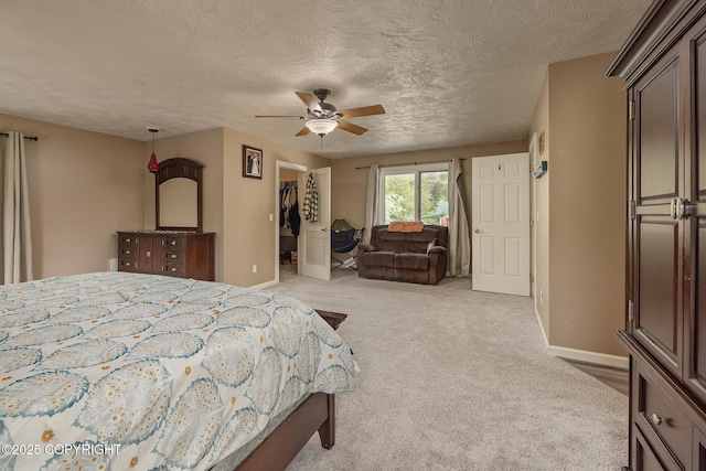 1061 E Agate Ln, Wasilla, AK 99654 - bedroom featuring baseboards, a spacious closet, carpet flooring, a textured ceiling, and a closet