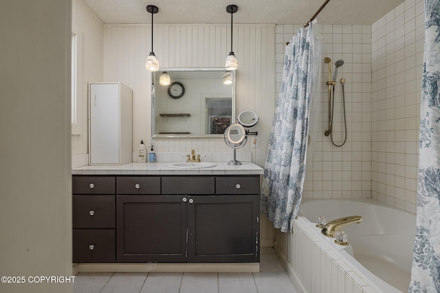 1061 E Agate Ln, Wasilla, AK 99654 - bathroom featuring vanity, tile patterned flooring, a textured ceiling, tiled shower / bath, and baseboards
