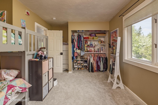 1061 E Agate Ln, Wasilla, AK 99654 - bedroom featuring carpet floors, a closet, a textured ceiling, baseboards, and refrigerator